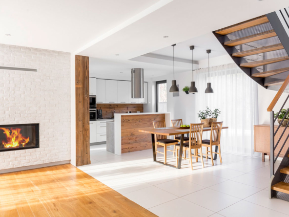 A dining room with wooden chairs and white tile floors.