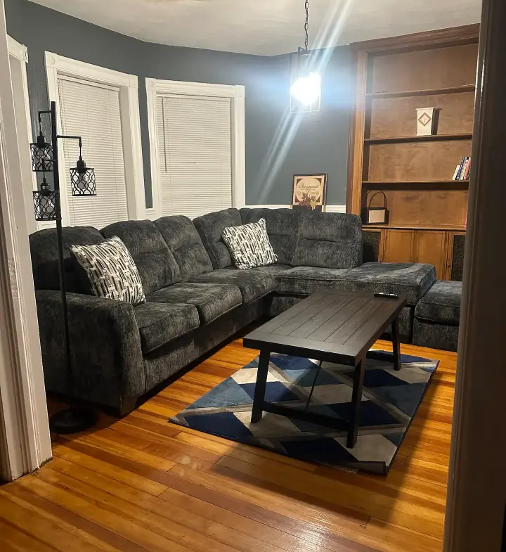 A living room with a couch and coffee table