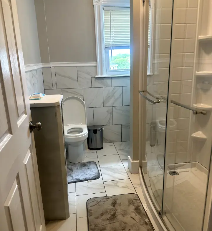 A bathroom with a toilet and shower in it