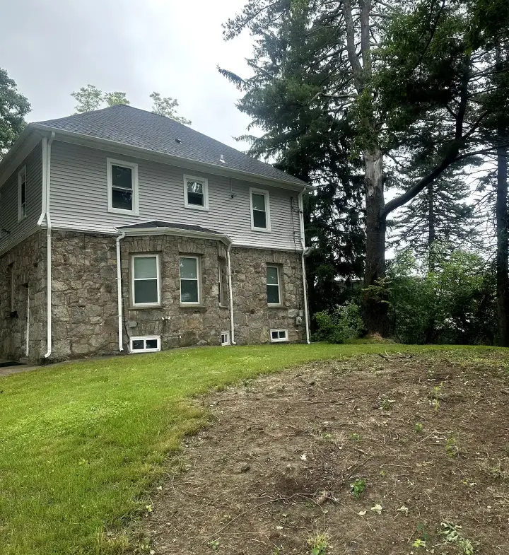 A large stone house sitting on top of a hill.