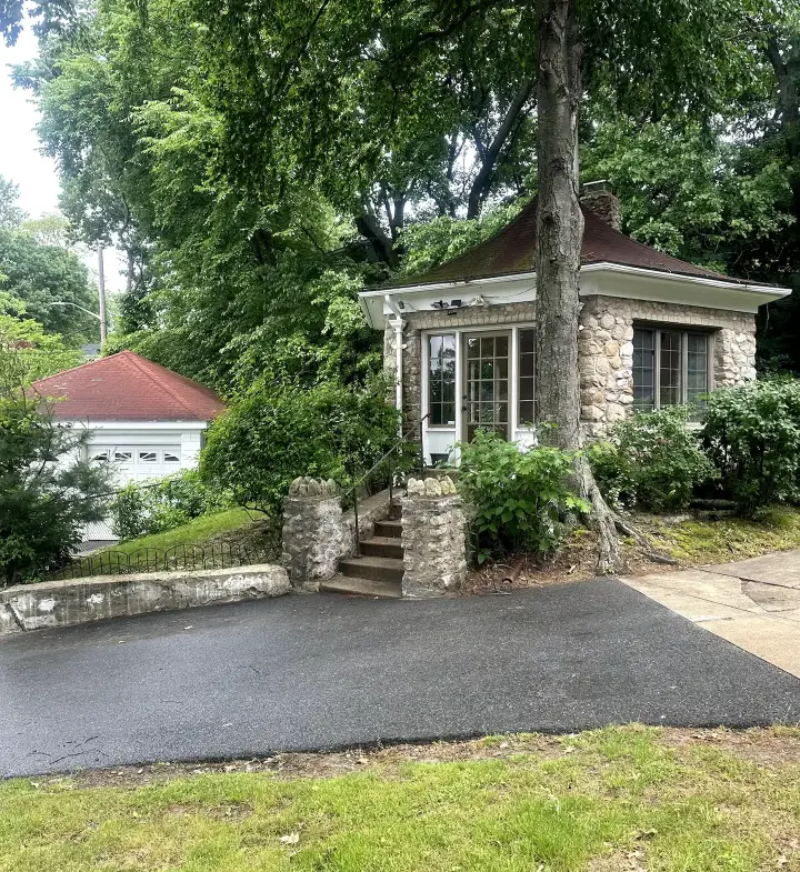 A small house with a tree in the middle of it