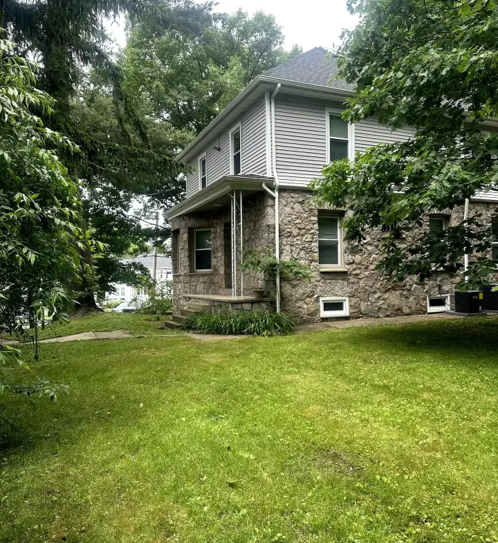 A large house with trees in the background