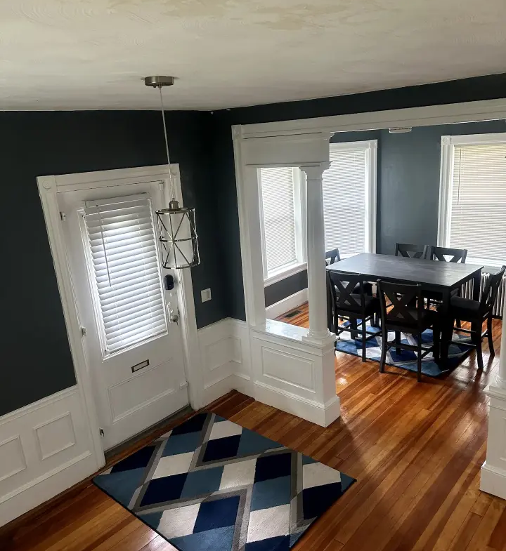 A dining room with a table and chairs in it