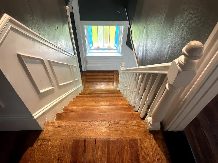 A view of the bottom of stairs from above.