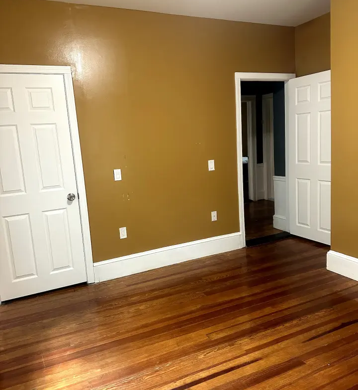 A room with two doors and a wooden floor