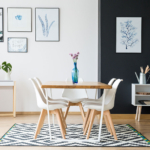 A dining room table with four chairs and a vase of flowers.