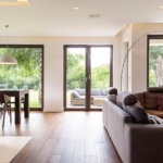 A living room with wooden floors and white walls.
