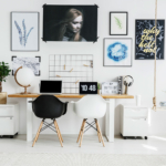 A room with two desks and a laptop on it