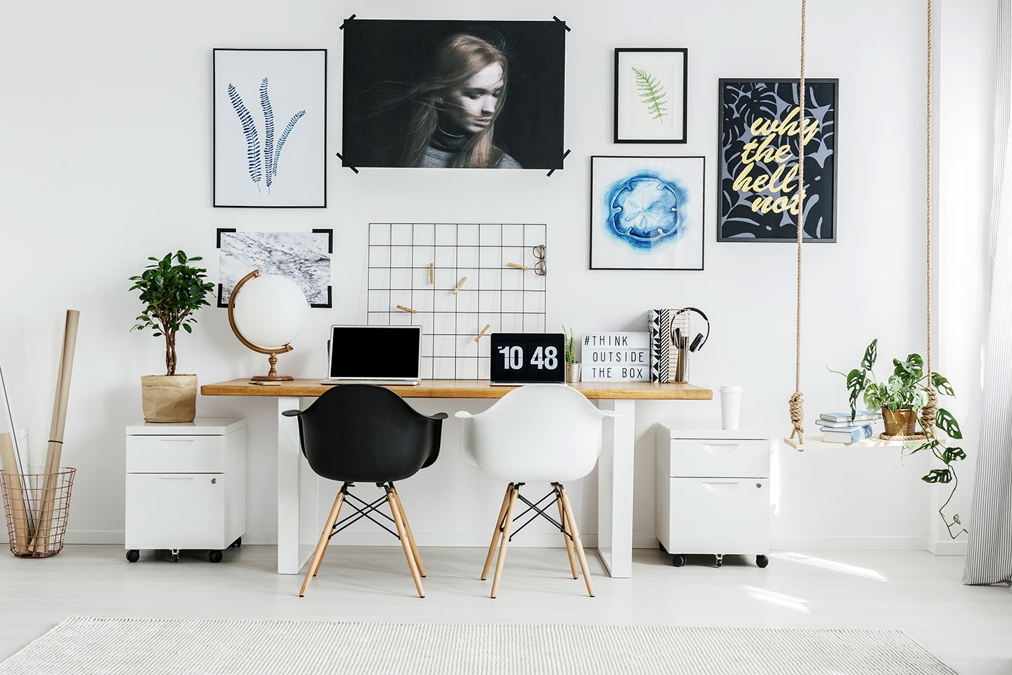 A room with two desks and a laptop on it