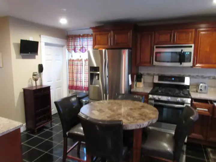 A kitchen with a table and chairs in it