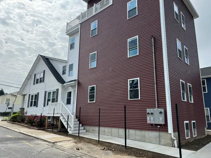 A row of houses with fenced in stairs.