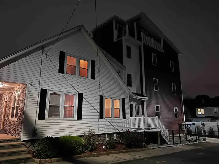 A building with windows lit up at night.