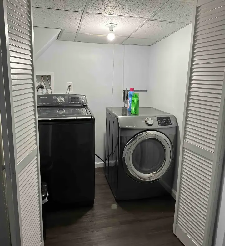 A washer and dryer in the corner of a room.