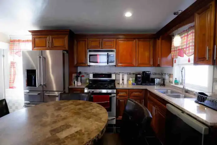 A kitchen with wooden cabinets and stainless steel appliances.