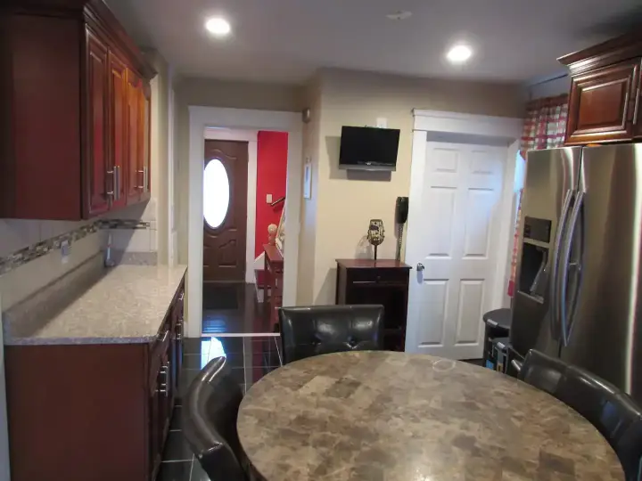 A kitchen with a table and chairs in it