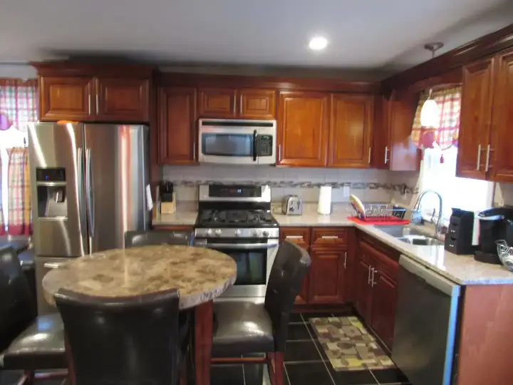 A kitchen with wooden cabinets and stainless steel appliances.