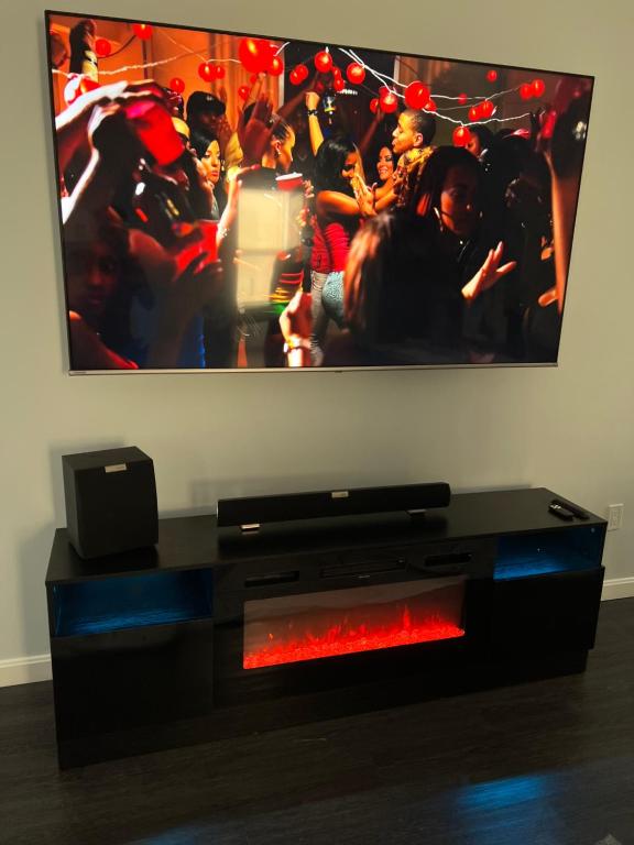 A television and speakers in front of a picture.