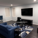 A living room with a couch, table and television.