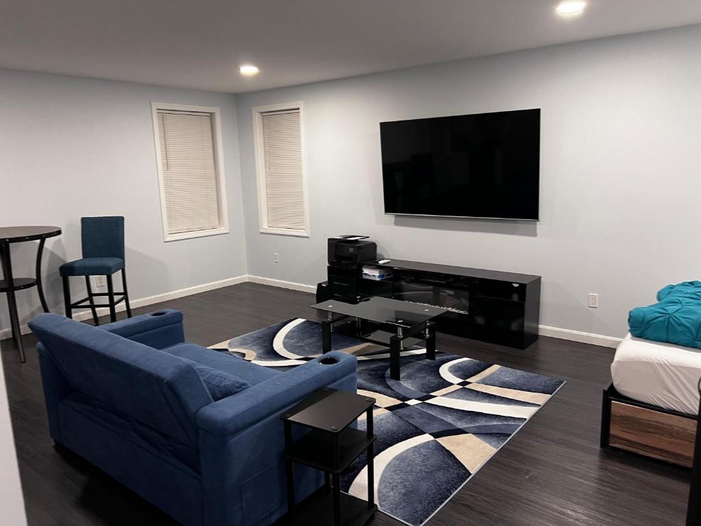 A living room with a couch, table and television.