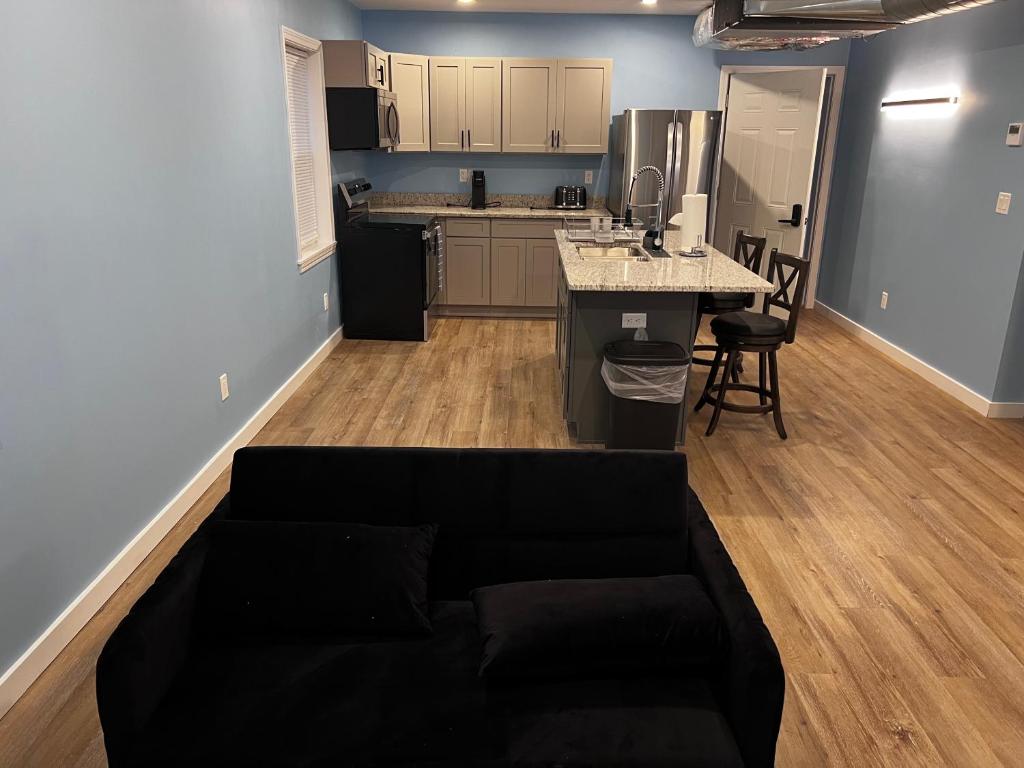 A living room with a couch and kitchen