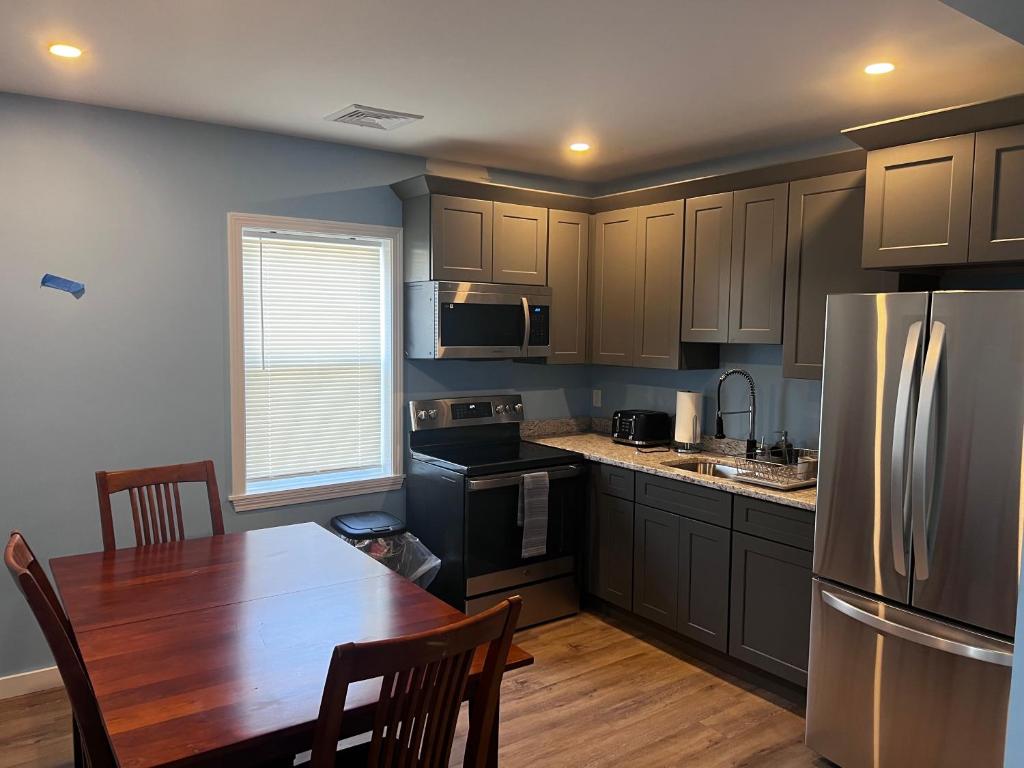 A kitchen with a table and chairs in it