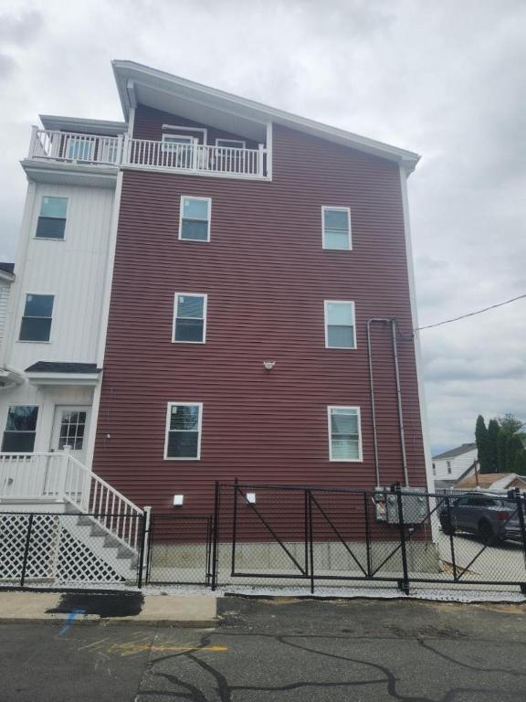 A building with red siding and white trim.