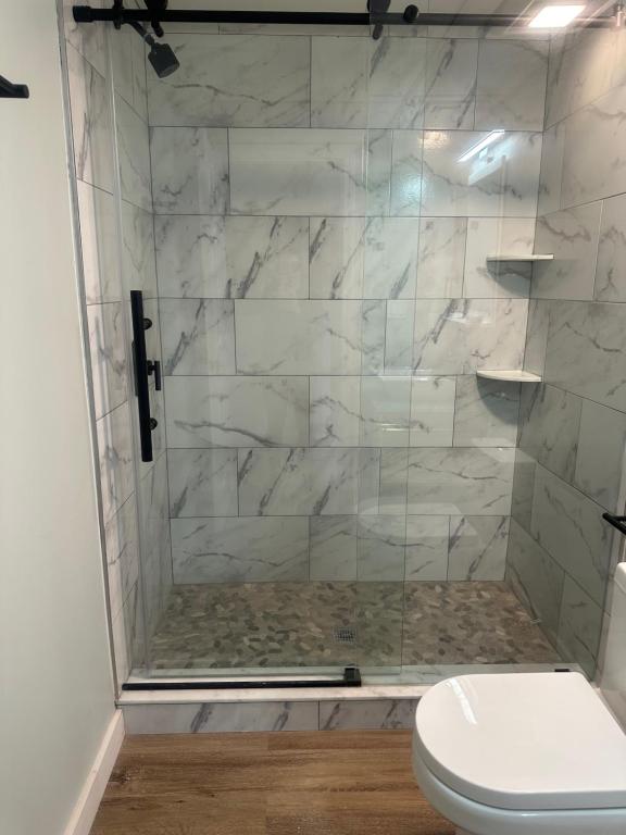 A bathroom with marble walls and floor