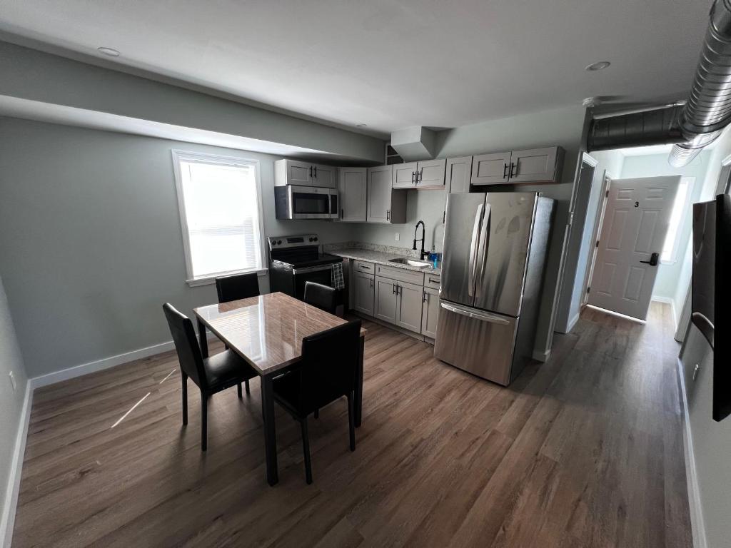 A kitchen with a table and chairs in it