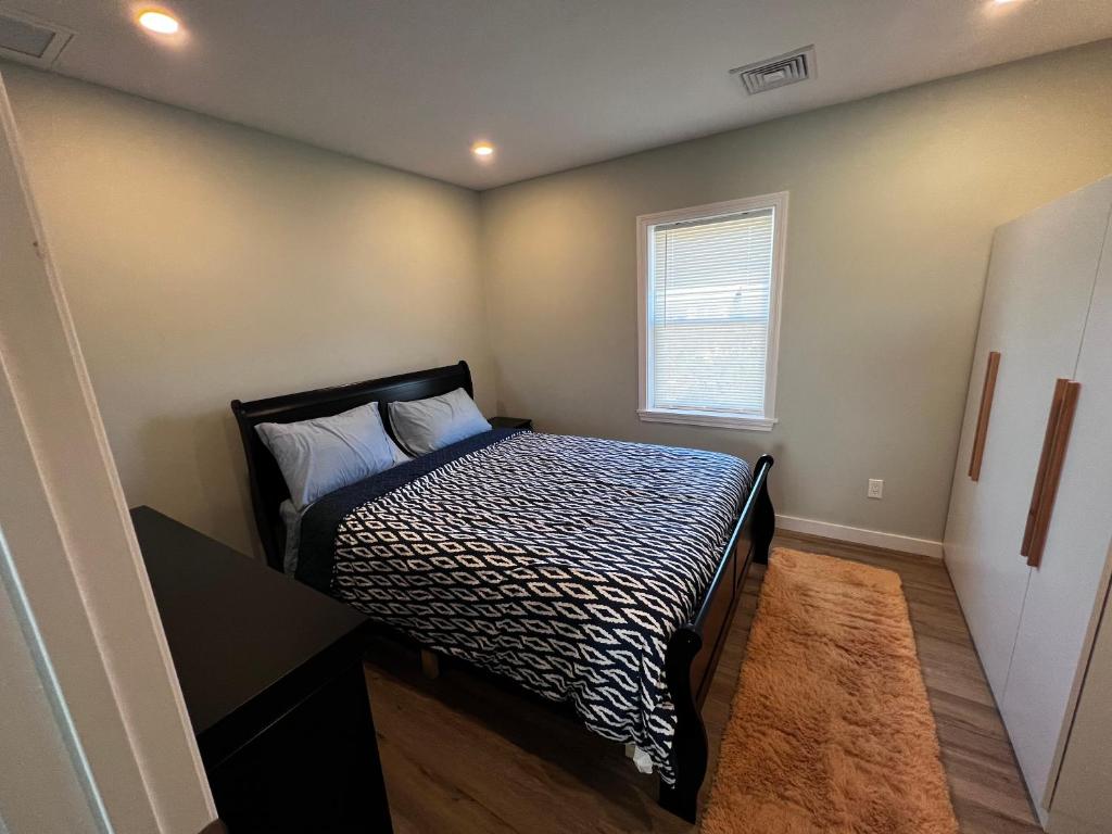 A bedroom with a bed and desk in it