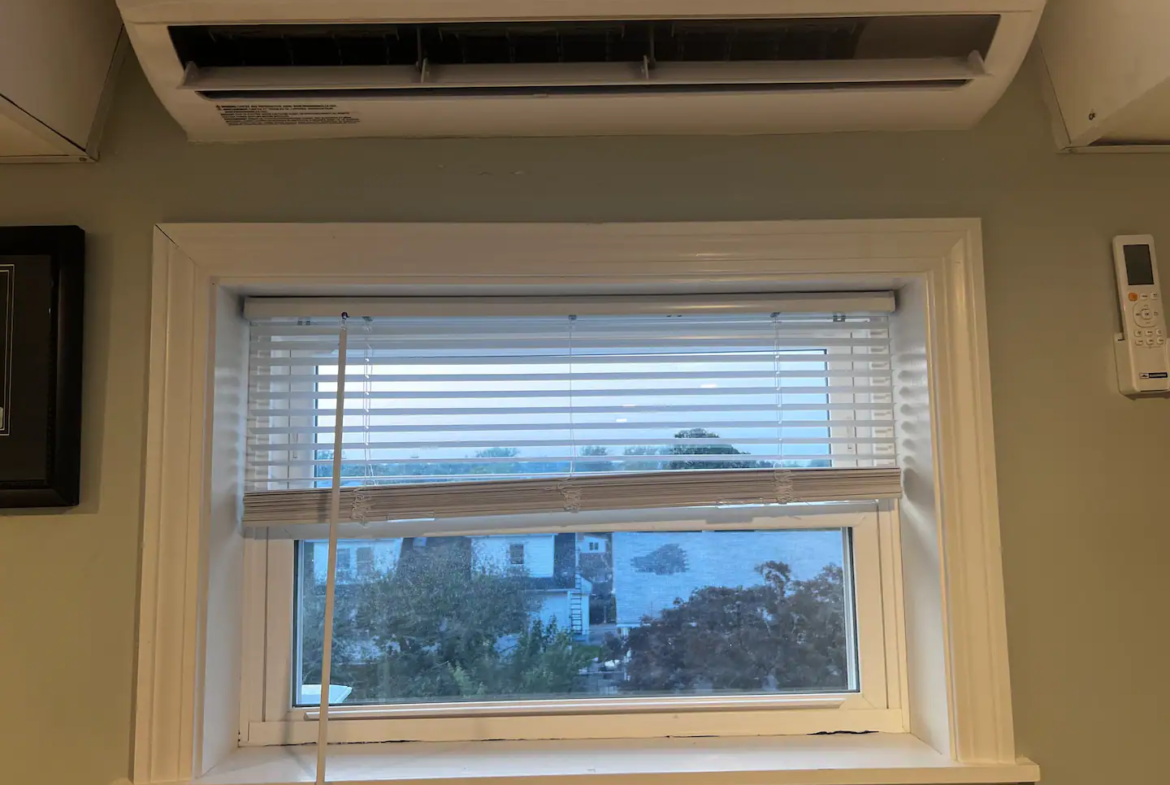 A window with blinds and a window shade